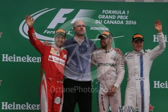 World © Octane Photographic Ltd. Mercedes AMG Petronas – Lewis Hamilton (1st), Scuderia Ferrari – Sebastian Vettel (2nd) and Williams Martini Racing, – Valtteri Bottas (3rd) with Evan Short (Constructors’ Trophy). Sunday 12th June 2016, F1 Canadian GP Podium, Circuit Gilles Villeneuve, Montreal, Canada. Digital Ref :1593LB1D4846