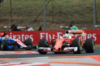 World © Octane Photographic Ltd. Scuderia Ferrari SF16-H – Sebastian Vettel and Manor Racing MRT05 - Pascal Wehrlein. Friday 22nd July 2016, F1 Hungarian GP Practice 1, Hungaroring, Hungary. Digital Ref :