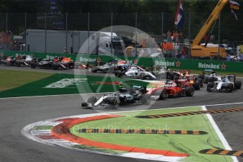 World © Octane Photographic Ltd. The Mercedes AMG Petronas W07 Hybrid of Nico Rosberg leads the 2 Ferraris of Vettel and Raikkonen and the Williams of Bottas through the 1st corner on the opening lap. Sunday 4th September 2016, F1 Italian GP Race, Monza, Italy. Digital Ref :1710LB2D6842