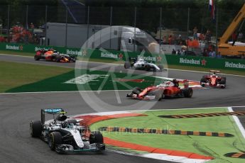 World © Octane Photographic Ltd. The Mercedes AMG Petronas W07 Hybrid of Nico Rosberg leads the 2 Ferraris of Vettel and Raikkonen and the Williams of Bottas through the 1st corner on the 2nd lap. Sunday 4th September 2016, F1 Italian GP Race, Monza, Italy. Digital Ref :1710LB2D6915