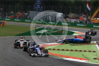 World © Octane Photographic Ltd. Sauber F1 Team C35 of Marcus Ericsson and the Haas F1 Team VF-16 of Esteban Gutierrez ahead of an out of shape Manor Racing MRT05 of Esteban Ocon and the trailing McLaren of Jenson Button. Sunday 4th September 2016, F1 Italian GP Race, Monza, Italy. Digital Ref :1710LB2D6957