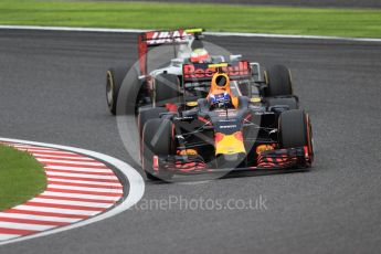 World © Octane Photographic Ltd. Red Bull Racing RB12 – Max Verstappen and Haas F1 Team VF-16 - Esteban Gutierrez. Sunday 9th October 2016, F1 Japanese GP - Race, Suzuka Circuit, Suzuka, Japan. Digital Ref :