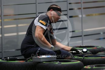 World © Octane Photographic Ltd. Scuderia Toro Rosso mechanic setting up Pirelli intermediate tyres. Thursday 15th September 2016, F1 Singapore GP Paddock, Marina Bay Circuit, Singapore. Digital Ref :1713CB5D3483