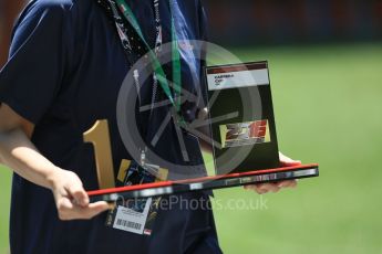 World © Octane Photographic Ltd. Porsche Carrera Cup Asia winners' trophy being delivered. Thursday 15th September 2016, F1 Singapore GP Paddock, Marina Bay Circuit, Singapore. Digital Ref : 1713CB5D3532