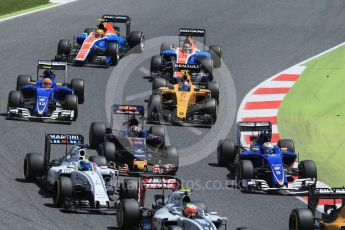 World © Octane Photographic Ltd. The pack heads through turns 1 and 2 on the 1st lap. Sunday 15th May 2016, F1 Spanish GP Race, Circuit de Barcelona Catalunya, Spain. Digital Ref :