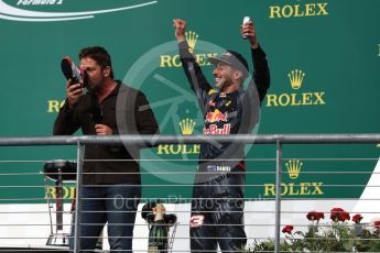 World © Octane Photographic Ltd. Gerard Butler drinks from the race boot of Red Bull Racing's Daniel Ricciardo (3rd). Sunday 23rd October 2016, F1 USA Grand Prix Podium, Austin, Texas – Circuit of the Americas (COTA). Digital Ref :1750LB1D4707