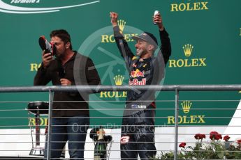World © Octane Photographic Ltd. Gerard Butler drinks from the race boot of Red Bull Racing's Daniel Ricciardo (3rd). Sunday 23rd October 2016, F1 USA Grand Prix Podium, Austin, Texas – Circuit of the Americas (COTA). Digital Ref :1750LB1D4707