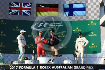 World © Octane Photographic Ltd. Formula 1 - Australian Grand Prix - Podium. Sebastian Vettel - Scuderia Ferrari SF70H, Lewis Hamilton and Valtteri Bottas - Mercedes AMG Petronas F1 W08 EQ Energy+ with Mark Webber. Albert Park Circuit. Sunday 26th March 2017. Digital Ref: 1803LB1D7949