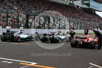 World © Octane Photographic Ltd. Formula 1 - Japanese Grand Prix - Saturday - Qualifying. Lewis Hamilton and Valtteri Bottas - Mercedes AMG Petronas F1 W08 EQ Energy+ and Sebastian Vettel - Scuderia Ferrari SF70H on track to be interviewed. Suzuka Circuit, Suzuka, Japan. Saturday 7th October 2017. Digital Ref:1977LB2D5024