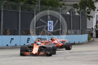 World © Octane Photographic Ltd. Formula 1 - Singapore Grand Prix - Practice 1. Fernando Alonso - McLaren Honda MCL32 and Kimi Raikkonen - Scuderia Ferrari SF70H. Marina Bay Street Circuit, Singapore. Friday 15th September 2017. Digital Ref: 1958LB2D1238