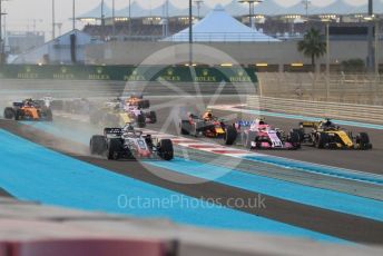 World © Octane Photographic Ltd. Formula 1 –  Abu Dhabi GP - Race. McLaren MCL33 – Fernando Alonso and Haas F1 Team VF-18 – Romain Grosjean run wide on the first corner. Yas Marina Circuit, Abu Dhabi. Sunday 25th November 2018.