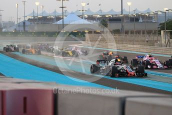 World © Octane Photographic Ltd. Formula 1 –  Abu Dhabi GP - Race. McLaren MCL33 – Fernando Alonso and Haas F1 Team VF-18 – Romain Grosjean and Kevin Magnussen run wide on the first corner. Yas Marina Circuit, Abu Dhabi. Sunday 25th November 2018.