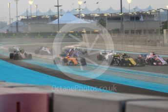 World © Octane Photographic Ltd. Formula 1 –  Abu Dhabi GP - Race. McLaren MCL33 – Fernando Alonso and Haas F1 Team VF-18 – Kevin Magnussen run wide on the first corner. Yas Marina Circuit, Abu Dhabi. Sunday 25th November 2018.