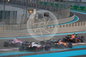 World © Octane Photographic Ltd. Formula 1 –  Abu Dhabi GP - Race. McLaren MCL33 – Fernando Alonso and Haas F1 Team VF-18 – Kevin Magnussen run wide on the first corner. Yas Marina Circuit, Abu Dhabi. Sunday 25th November 2018.
