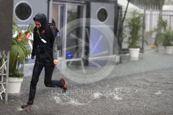 World © Octane Photographic Ltd. Formula 1 – Italian GP - Paddock. Red Bull crew running through the puddles Autodromo Nazionale di Monza, Monza, Italy. Friday 31st August 2018.