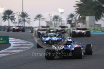 World © Octane Photographic Ltd. Formula 1 – Abu Dhabi GP - Race. Scuderia Toro Rosso STR14 – Pierre Gasly with missing front wing trails the pack up the hill through turn 2. Yas Marina Circuit, Abu Dhabi, UAE. Sunday 1st December 2019.