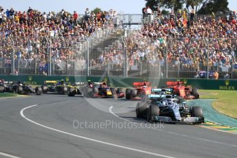 World © Octane Photographic Ltd. Formula 1 – Australian GP Race. Mercedes AMG Petronas Motorsport AMG F1 W10 EQ Power+ - Valtteri Bottas and Lewis Hamilton lead in turn 1 on lap 1. Melbourne, Australia. Sunday 17th March 2019.