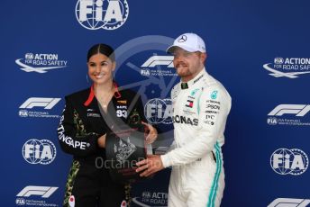 World © Octane Photographic Ltd. Formula 1 – British GP - Qualifying. Mercedes AMG Petronas Motorsport AMG F1 W10 EQ Power+ - Valtteri Bottas receives the Pirelli Pole Position Award from the Pirelli Representative, pop star Mabel McVey. Silverstone Circuit, Towcester, Northamptonshire. Saturday 13th July 2019.