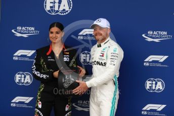 World © Octane Photographic Ltd. Formula 1 – British GP - Qualifying. Mercedes AMG Petronas Motorsport AMG F1 W10 EQ Power+ - Valtteri Bottas receives the Pirelli Pole Position Award from the Pirelli Representative, pop star Mabel McVey. Silverstone Circuit, Towcester, Northamptonshire. Saturday 13th July 2019.