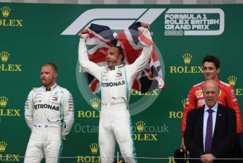 World © Octane Photographic Ltd. Formula 1 – British GP - Race - Podium. Mercedes AMG Petronas Motorsport AMG F1 W10 EQ Power+ - Lewis Hamilton, Valtteri Bottas and Scuderia Ferrari SF90 – Charles Leclerc. Silverstone Circuit, Towcester, Northamptonshire. Sunday 14th July 2019.