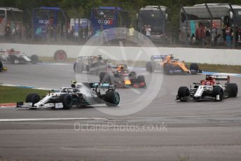 World © Octane Photographic Ltd. Formula 1 – German GP - Race. Mercedes AMG Petronas Motorsport AMG F1 W10 EQ Power+ Valtteri Bottas ahead of Alfa Romeo Racing C38 – Kimi Raikkonen and the rest of the pack. Hockenheimring, Hockenheim, Germany. Sunday 28th July 2019.