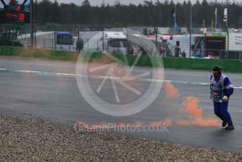 World © Octane Photographic Ltd. Formula 1 – German GP - Race.  A marshal kicks an orange smoke marker clear that was thrown on track from a Max Verstappen fam. Hockenheimring, Hockenheim, Germany. Sunday 28th July 2019.