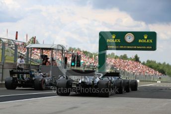 World © Octane Photographic Ltd. Formula 1 – Hungarian GP - Practice 3. Mercedes AMG Petronas Motorsport AMG F1 W10 EQ Power+ - Lewis Hamilton and Valtteri Bottas with Rich Energy Haas F1 Team VF19 – Romain Grosjean. Hungaroring, Budapest, Hungary. Saturday 3rd August 2019.