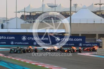 World © Octane Photographic Ltd. Formula 1 – Etihad F1 Grand Prix Abu Dhabi. Mercedes AMG Petronas F1 Team F1 W12 - Lewis Hamilton leads the Red Bull Racing Honda RB16B of Max Verstappen away from the line at race start. Yas Marina Circuit, Abu Dhabi. Sunday 12th December 2021 Race.