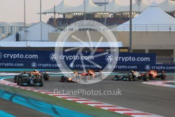 World © Octane Photographic Ltd. Formula 1 – Etihad F1 Grand Prix Abu Dhabi. Mercedes AMG Petronas F1 Team F1 W12 - Lewis Hamilton leads the Red Bull Racing Honda RB16B of Max Verstappen away from the line at race start. Yas Marina Circuit, Abu Dhabi. Sunday 12th December 2021 Race.