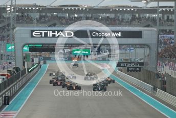 World © Octane Photographic Ltd. Formula 1 – Etihad F1 Grand Prix Abu Dhabi. Mercedes AMG Petronas F1 Team F1 W12 - Lewis Hamilton leads the Red Bull Racing Honda RB16B of Max Verstappen away from the line at race start. Yas Marina Circuit, Abu Dhabi. Sunday 12th December 2021 Race.