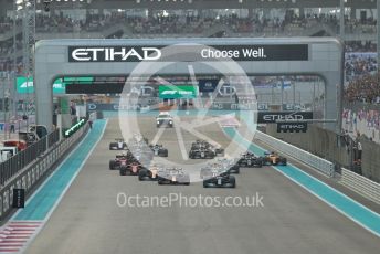 World © Octane Photographic Ltd. Formula 1 – Etihad F1 Grand Prix Abu Dhabi. Mercedes AMG Petronas F1 Team F1 W12 - Lewis Hamilton leads the Red Bull Racing Honda RB16B of Max Verstappen away from the line at race start. Yas Marina Circuit, Abu Dhabi. Sunday 12th December 2021 Race.