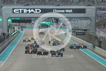 World © Octane Photographic Ltd. Formula 1 – Etihad F1 Grand Prix Abu Dhabi. Mercedes AMG Petronas F1 Team F1 W12 - Lewis Hamilton leads the Red Bull Racing Honda RB16B of Max Verstappen away from the line at race start. Yas Marina Circuit, Abu Dhabi. Sunday 12th December 2021 Race.