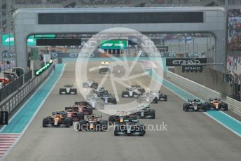 World © Octane Photographic Ltd. Formula 1 – Etihad F1 Grand Prix Abu Dhabi. Mercedes AMG Petronas F1 Team F1 W12 - Lewis Hamilton leads the Red Bull Racing Honda RB16B of Max Verstappen away from the line at race start. Yas Marina Circuit, Abu Dhabi. Sunday 12th December 2021 Race.