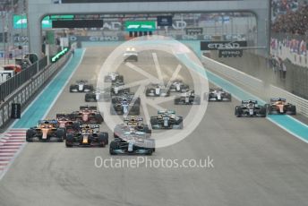 World © Octane Photographic Ltd. Formula 1 – Etihad F1 Grand Prix Abu Dhabi. Mercedes AMG Petronas F1 Team F1 W12 - Lewis Hamilton leads the Red Bull Racing Honda RB16B of Max Verstappen away from the line at race start. Yas Marina Circuit, Abu Dhabi. Sunday 12th December 2021 Race.