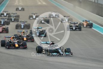 World © Octane Photographic Ltd. Formula 1 – Etihad F1 Grand Prix Abu Dhabi. Mercedes AMG Petronas F1 Team F1 W12 - Lewis Hamilton leads the Red Bull Racing Honda RB16B of Max Verstappen away from the line at race start. Yas Marina Circuit, Abu Dhabi. Sunday 12th December 2021 Race.