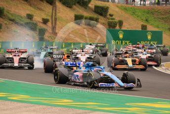 World © Octane Photographic Ltd. Formula 1– Hungarian Grand Prix - Hungaroring, Hungary. Sunday 31st July 2022 Race. BWT Alpine F1 Team A522 - Fernando Alonso and Oracle Red Bull Racing RB18 – Max Verstappen. Alfa Romeo F1 Team Orlen C42 - Valtteri Bottas locks a wheel.