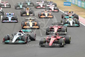 World © Octane Photographic Ltd. Formula 1– Hungarian Grand Prix - Hungaroring, Hungary. Sunday 31st July 2022 Race. Mercedes-AMG Petronas F1 Team F1 W13 - George Russell and Scuderia Ferrari F1-75 - Carlos Sainz lead the pack.