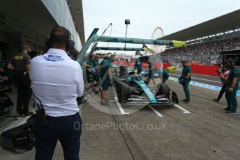 World © Octane Photographic Ltd. Formula 1 – Japanese Grand Prix - Suzuka Circuit, Japan. Saturday 8th October 2022. Practice 3. FIA personnel watches a Aston Martin Aramco Cognizant F1 Team AMR22 - Sebastian Vettel pit stop