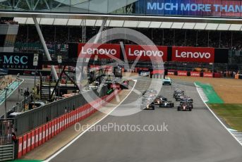 World © Octane Photographic Ltd. Formula 1 – British Grand Prix - Silverstone. Sunday 3rd July 2022. Race. Oracle Red Bull Racing RB18 – Max Verstappen and Scuderia Ferrari F1-75 - Carlos Sainz head the pack with Mercedes-AMG Petronas F1 Team F1 W13 - Lewis Hamilton and Scuderia Ferrari F1-75 - Charles Leclerc behind