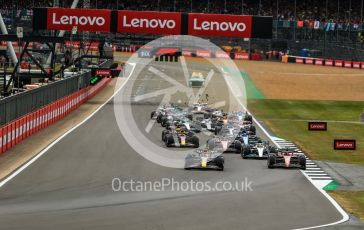World © Octane Photographic Ltd. Formula 1 – British Grand Prix - Silverstone. Sunday 3rd July 2022. Race. Oracle Red Bull Racing RB18 – Max Verstappen and Scuderia Ferrari F1-75 - Carlos Sainz head the pack with Mercedes-AMG Petronas F1 Team F1 W13 - Lewis Hamilton and Scuderia Ferrari F1-75 - Charles Leclerc behind. Some contact starting.
