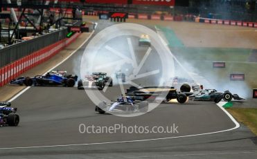 World © Octane Photographic Ltd. Formula 1 – British Grand Prix - Silverstone. Sunday 3rd July 2022. Race. Alfa Romeo F1 Team Orlen C42 - Guanyu Zhou slides inverted towards the gravel trap and barrier as Williams Racing FW44 - Alex Albon impacts the pit wall and Mercedes-AMG Petronas F1 Team F1 W13 - George Russell also slides onto the grass after the collison.