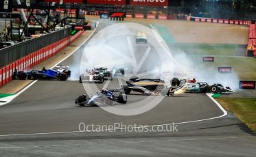 World © Octane Photographic Ltd. Formula 1 – British Grand Prix - Silverstone. Sunday 3rd July 2022. Race. Alfa Romeo F1 Team Orlen C42 - Guanyu Zhou slides inverted towards the gravel trap and barrier as Williams Racing FW44 - Alex Albon impacts the pit wall.