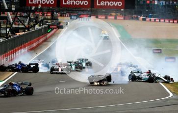 World © Octane Photographic Ltd. Formula 1 – British Grand Prix - Silverstone. Sunday 3rd July 2022. Race. Alfa Romeo F1 Team Orlen C42 - Guanyu Zhou slides inverted towards the gravel trap and barrier as Williams Racing FW44 - Alex Albon impacts the pit wall and Mercedes-AMG Petronas F1 Team F1 W13 - George Russell also slides onto the grass after the collison.