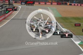 World © Octane Photographic Ltd. Formula 1 – British Grand Prix - Silverstone. Sunday 3rd July 2022. Race. Oracle Red Bull Racing RB18 – Max Verstappen and Scuderia Ferrari F1-75 - Carlos Sainz head the pack with Mercedes-AMG Petronas F1 Team F1 W13 - Lewis Hamilton and Scuderia Ferrari F1-75 - Charles Leclerc behind. Some contact starting.