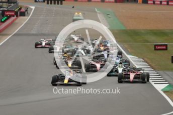 World © Octane Photographic Ltd. Formula 1 – British Grand Prix - Silverstone. Sunday 3rd July 2022. Race. Oracle Red Bull Racing RB18 – Max Verstappen and Scuderia Ferrari F1-75 - Carlos Sainz head the pack with Mercedes-AMG Petronas F1 Team F1 W13 - Lewis Hamilton and Scuderia Ferrari F1-75 - Charles Leclerc behind. George Russel moving over towards Zhou.