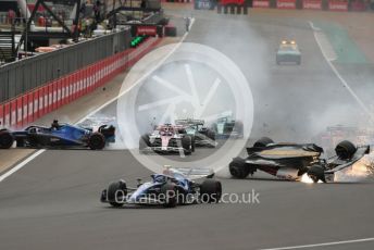 World © Octane Photographic Ltd. Formula 1 – British Grand Prix - Silverstone. Sunday 3rd July 2022. Race. Alfa Romeo F1 Team Orlen C42 - Guanyu Zhou slides inverted towards the gravel trap and barrier as Williams Racing FW44 - Alex Albon impacts the pit wall.