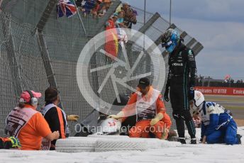 World © Octane Photographic Ltd. Formula 1 – British Grand Prix - Silverstone. Sunday 3rd July 2022. Race. Alfa Romeo F1 Team Orlen C42 - Guanyu Zhou's car wedged behind the barrier with him still in it as Mercedes-AMG Petronas F1 Team F1 W13 - George Russell watches the extraction.