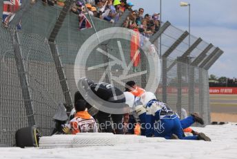World © Octane Photographic Ltd. Formula 1 – British Grand Prix - Silverstone. Sunday 3rd July 2022. Race. Alfa Romeo F1 Team Orlen C42 - Guanyu Zhou's car wedged behind the barrier with him still in it.