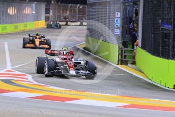 World © Octane Photographic Ltd. Formula 1 – Singapore Grand Prix - Marina Bay, Singapore. Friday 30th September 2022. Practice 2. Alfa Romeo F1 Team Orlen C42 - Valtteri Bottas, McLaren F1 Team MCL36 - Lando Norris an d Aston Martin Aramco Cognizant F1 Team AMR22 - Lance Stroll.