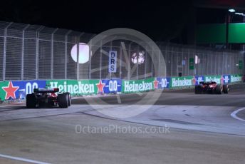 World © Octane Photographic Ltd. Formula 1 – Singapore Grand Prix - Marina Bay, Singapore. Friday 30th September 2022. Practice 2. Scuderia Ferrari F1-75 - Carlos Sainz and Alfa Romeo F1 Team Orlen C42 - Guanyu Zhou.